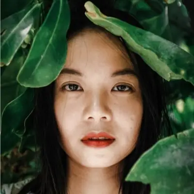 Portrait among green leaves
